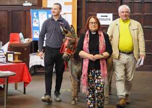 Photo from last years Animal Blessing Service the reverend vet walking with a donkey during special pet service in 2024
